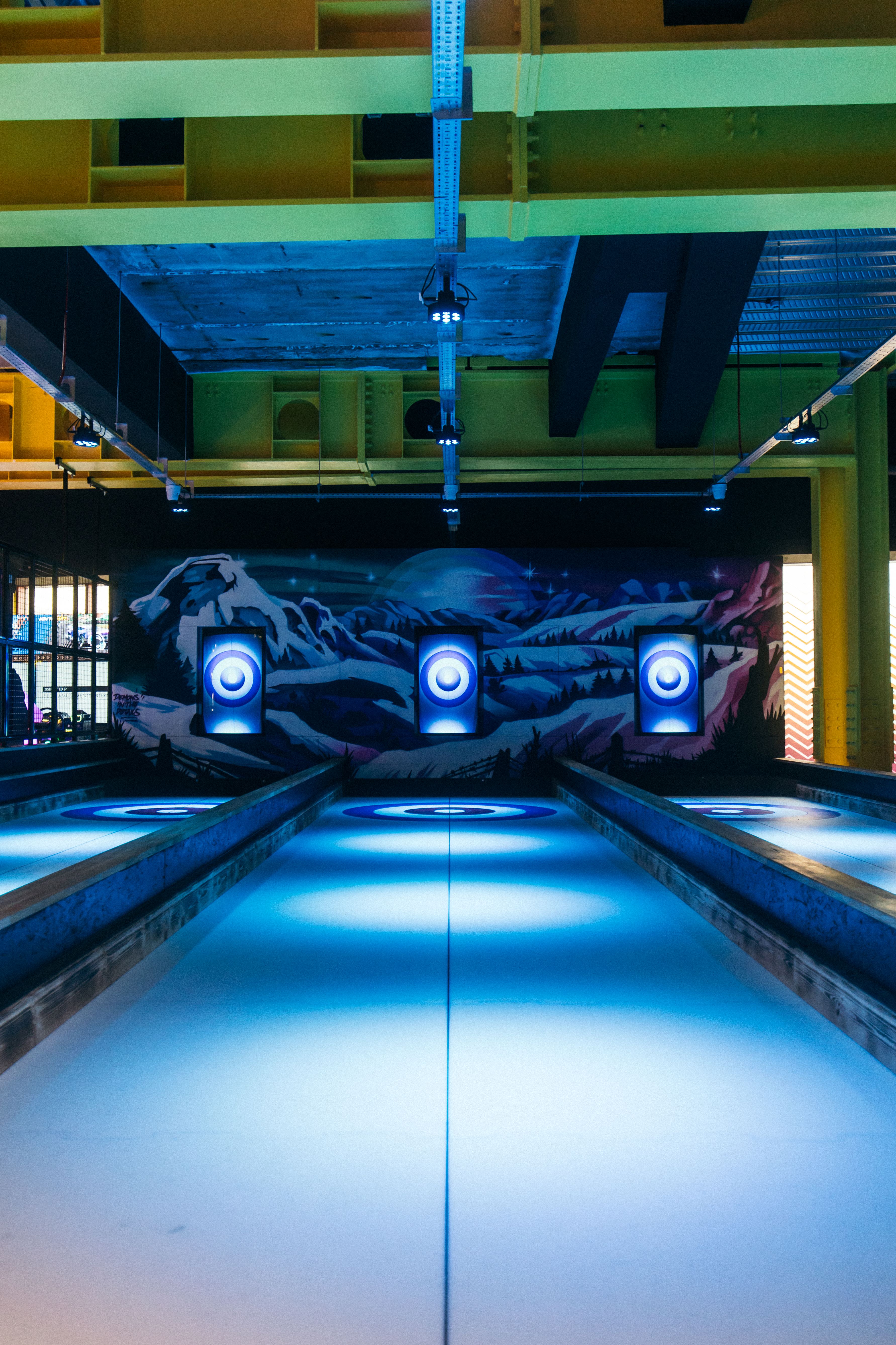 Vibrant event space at The Glide Zone, illuminated bowling lanes in Belfast.