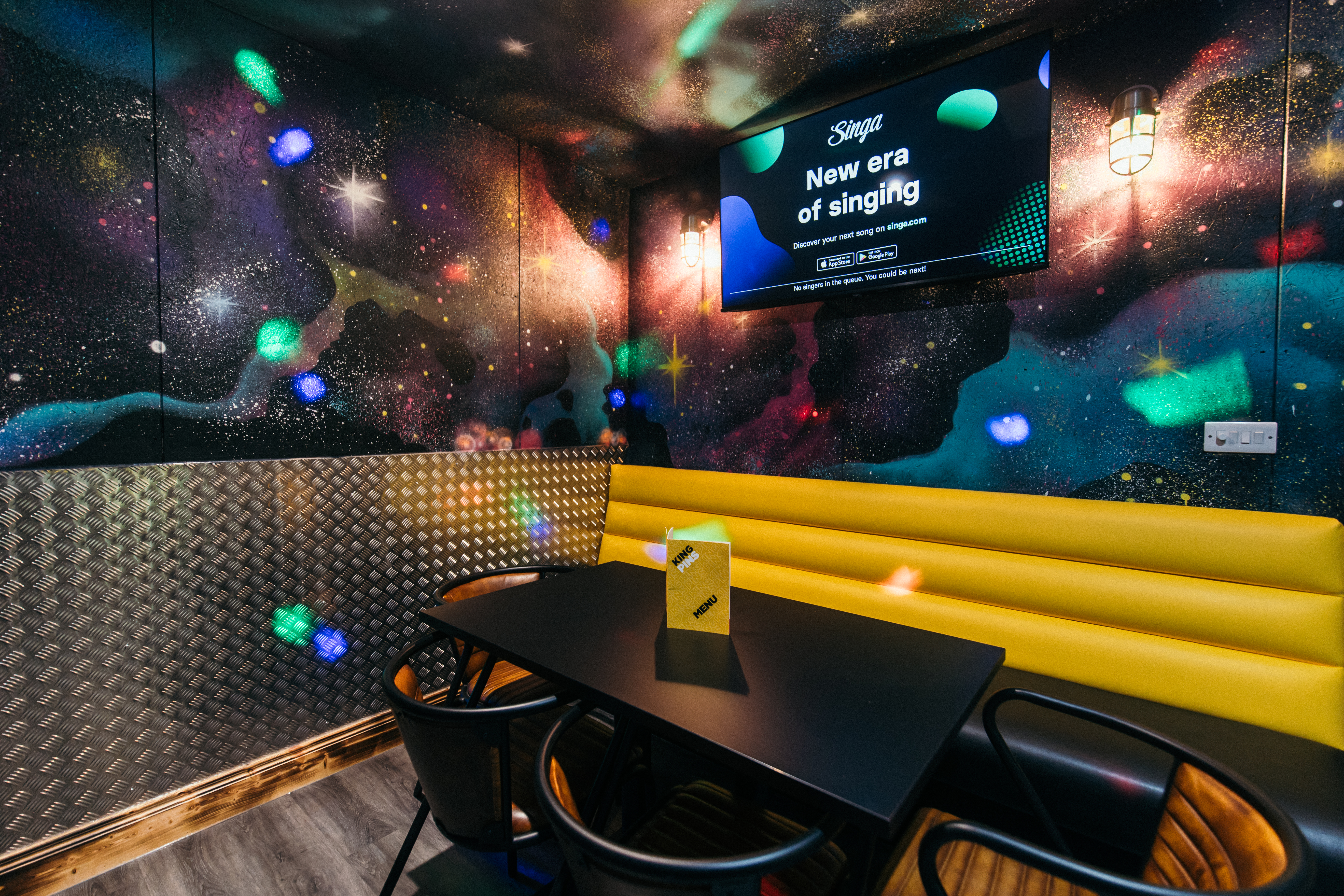 Vibrant karaoke room with galaxy mural, ideal for corporate events in Belfast.