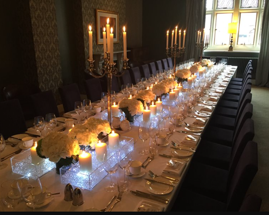 Elegant dining table with floral centerpieces for sophisticated events in Aspire Leeds.
