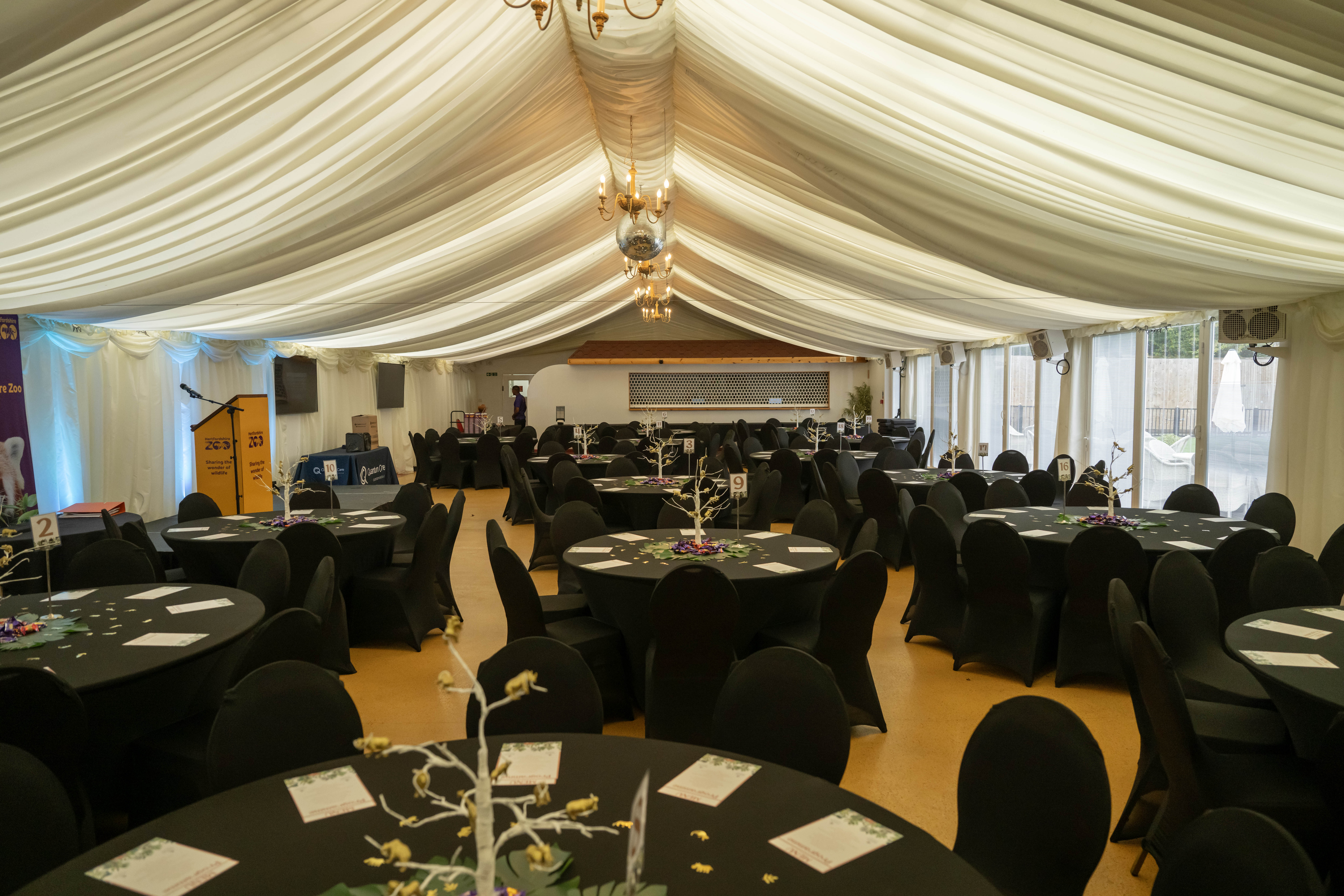 Elegant event space in Hertfordshire Zoo with round tables, ideal for conferences or gala dinners.
