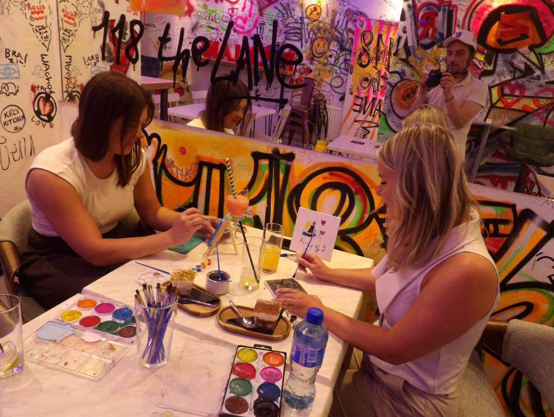 Vibrant artistic venue with graffiti backdrop for creative gatherings and networking events.