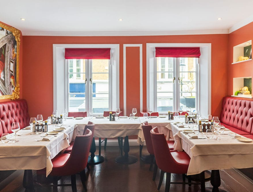 Sophisticated Restaurant & Bar in San Pietro, London with plush red seating for intimate dining.