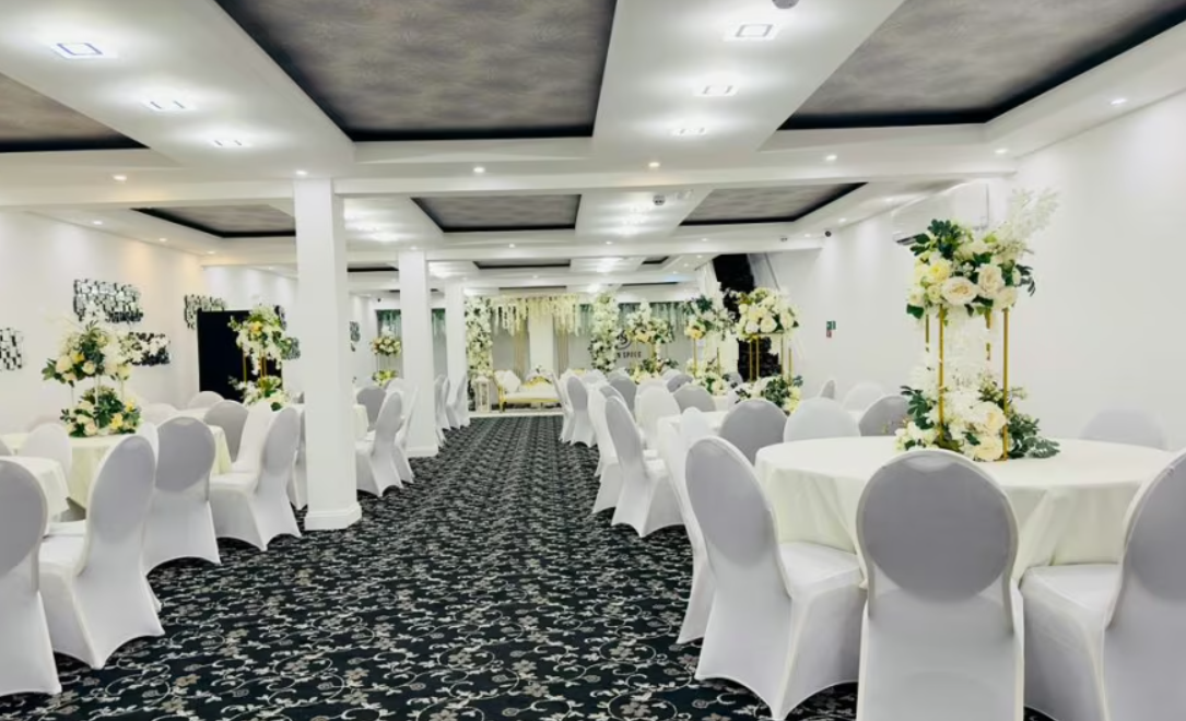 Elegant wedding venue with floral centerpieces in Hidden Space Function Hall.