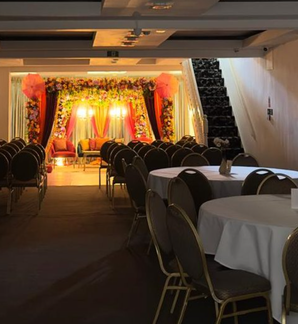 Whole Venue in Hidden Space Function Hall with floral backdrop for formal gatherings.