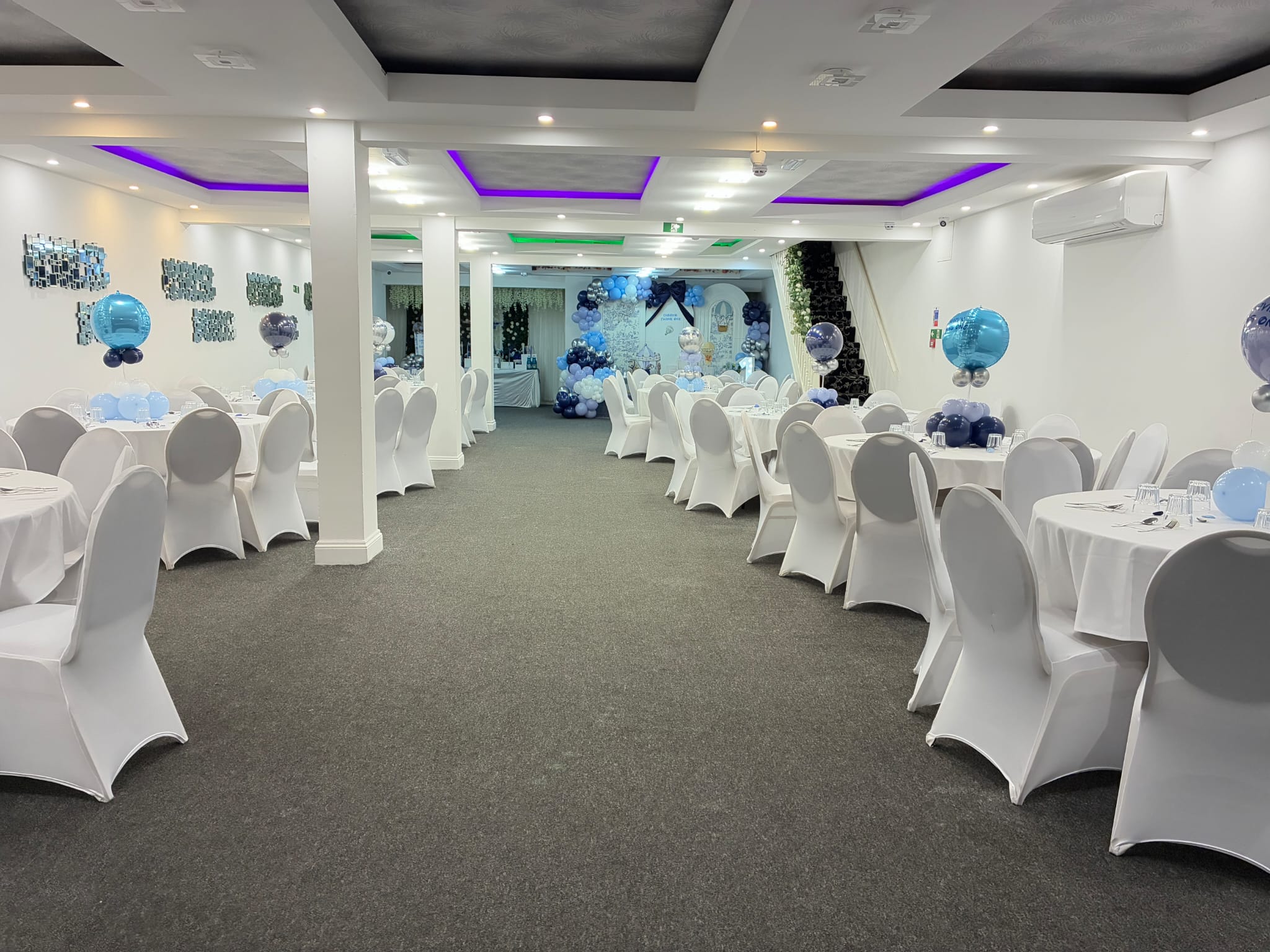 Elegant event space with blue balloon decor, ideal for corporate functions and celebrations.