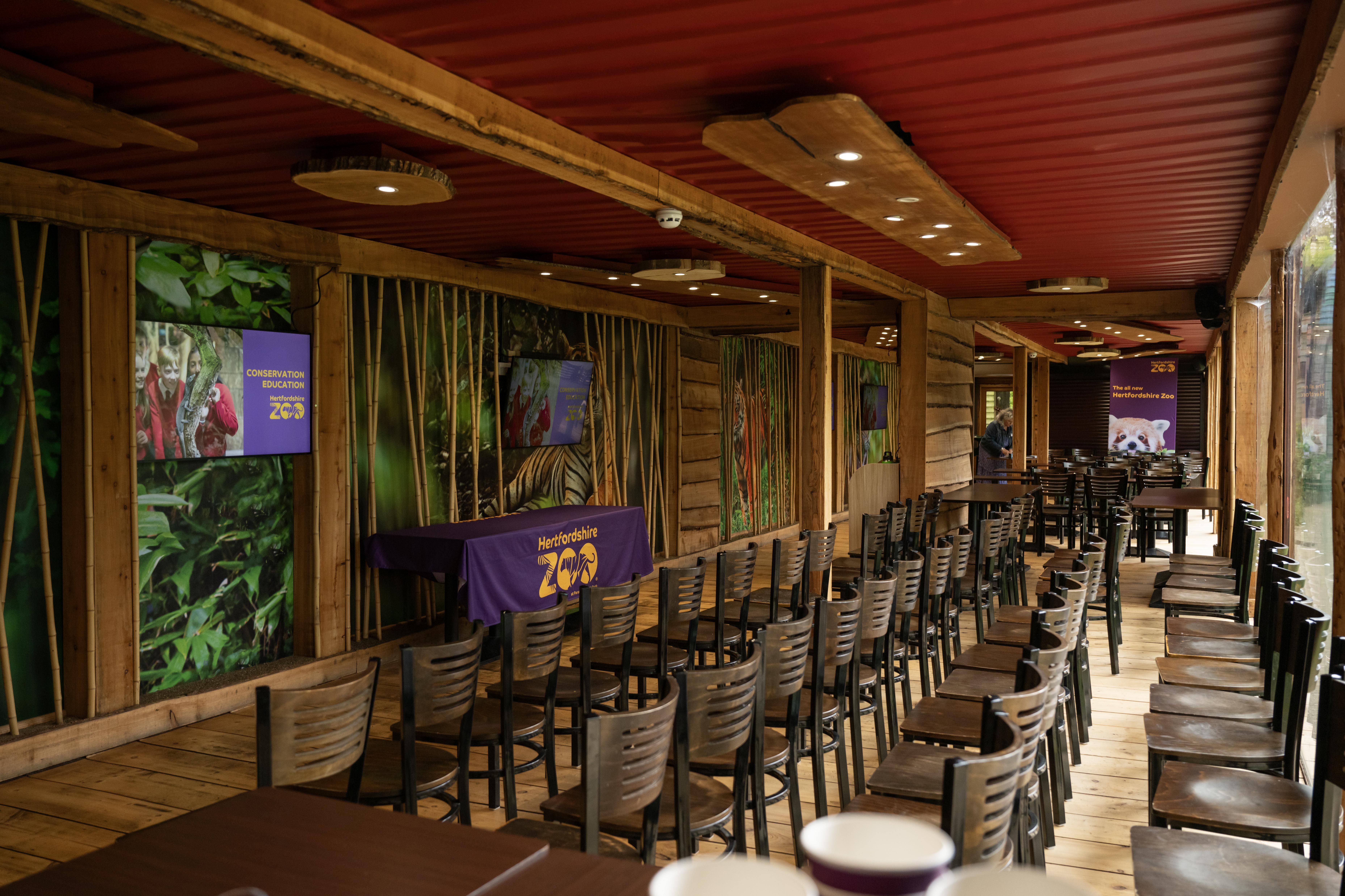 Tiger Venue at Hertfordshire Zoo: rustic décor, vibrant greenery for events and meetings.