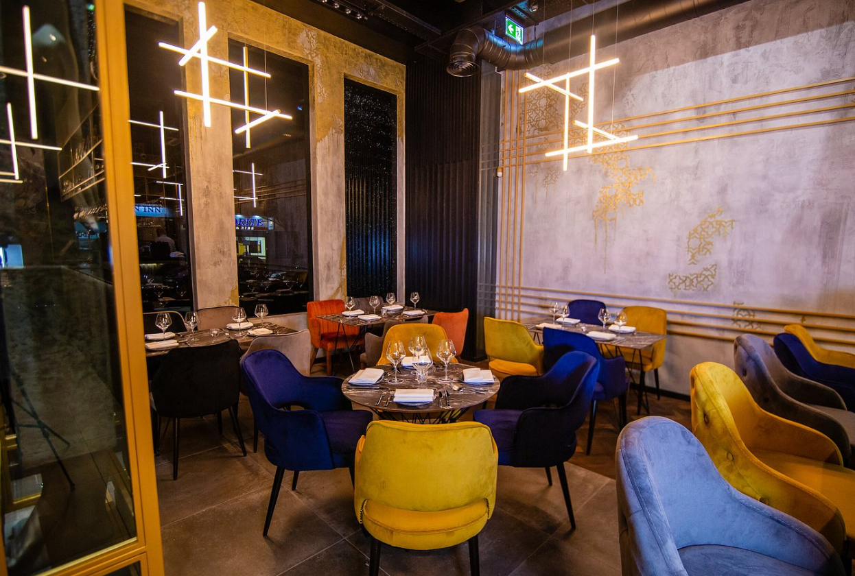 Modern dining area with vibrant chairs, ideal for upscale events and receptions.