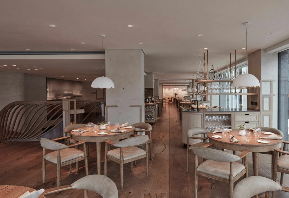Modern restaurant interior with wooden floors, perfect for meetings and events.