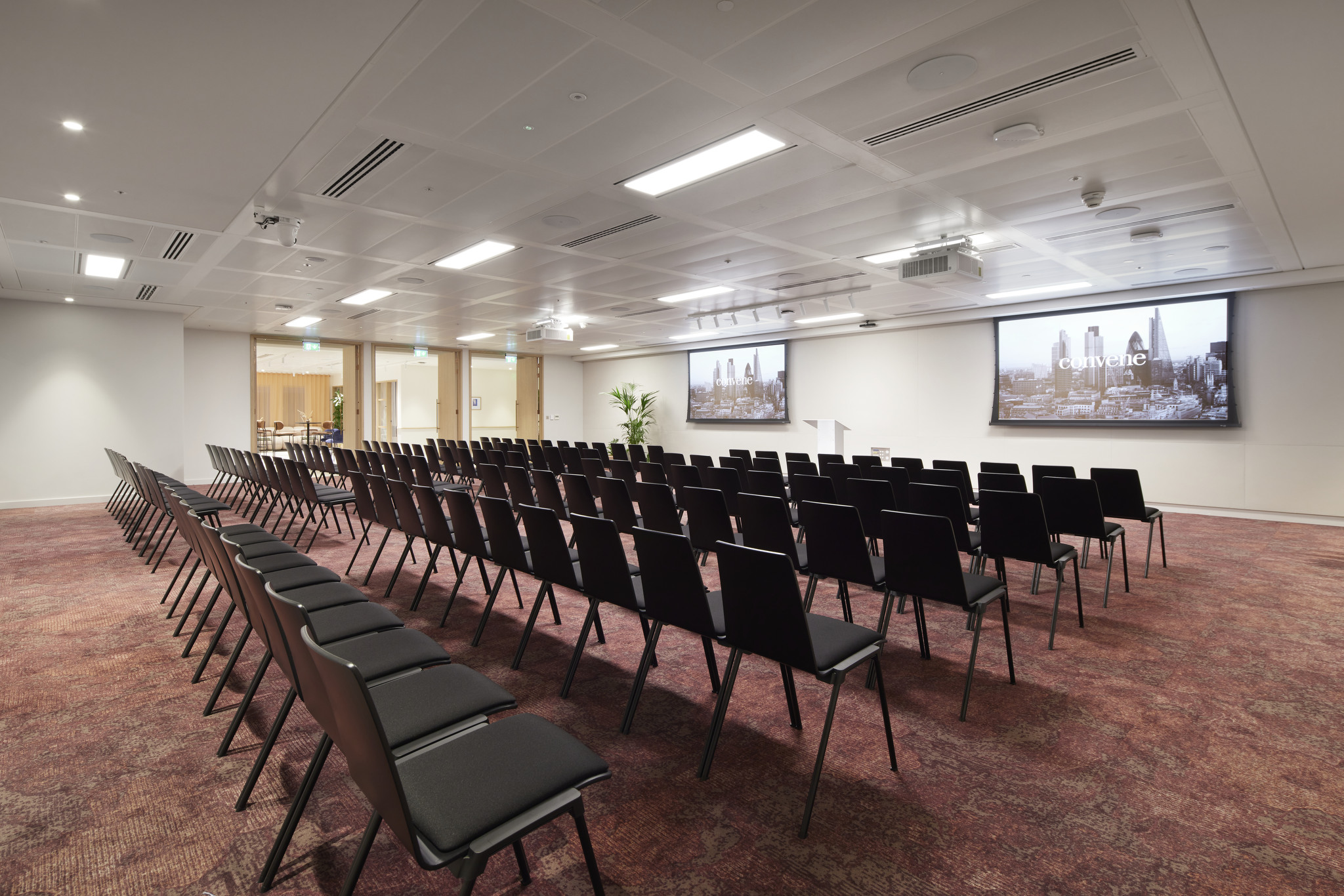 Conference room at Bon Hub with black chairs, ideal for meetings and events.