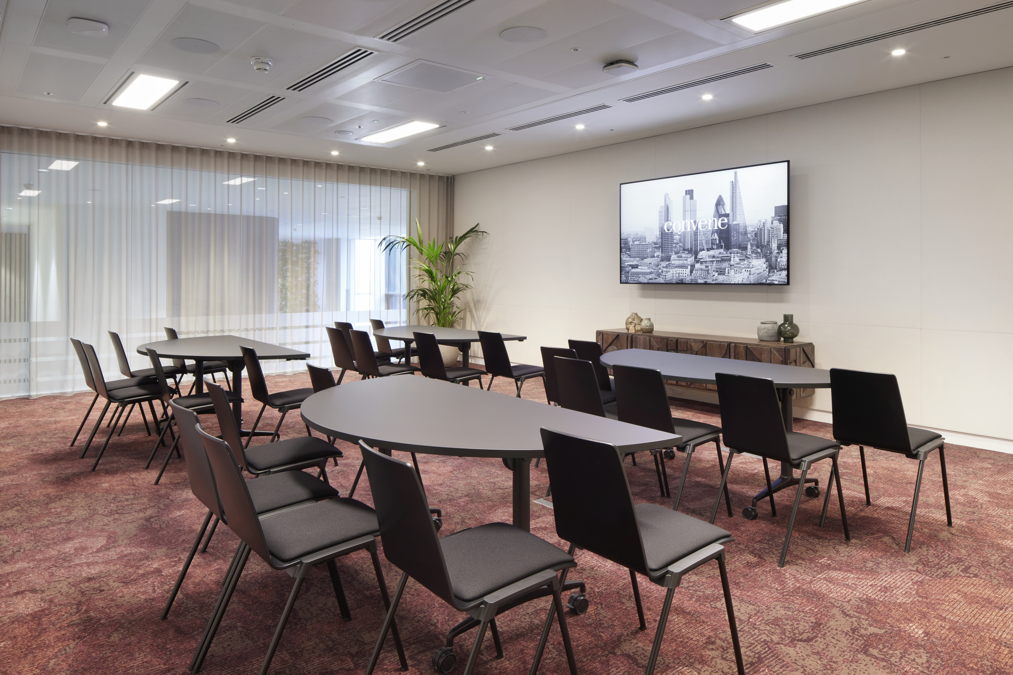 Ivory Studio at Convene 200 Aldersgate, featuring modular tables for workshops.