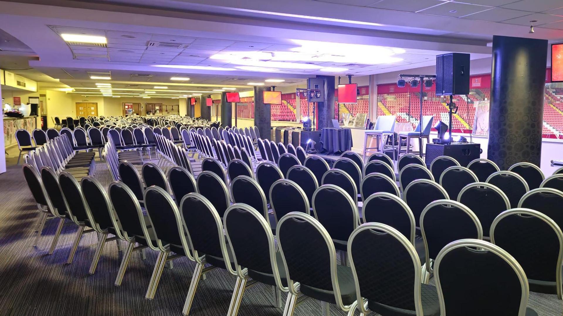 North Stand Suite at Charlton Athletic: seated event with audio-visual setup, ideal for speeches.