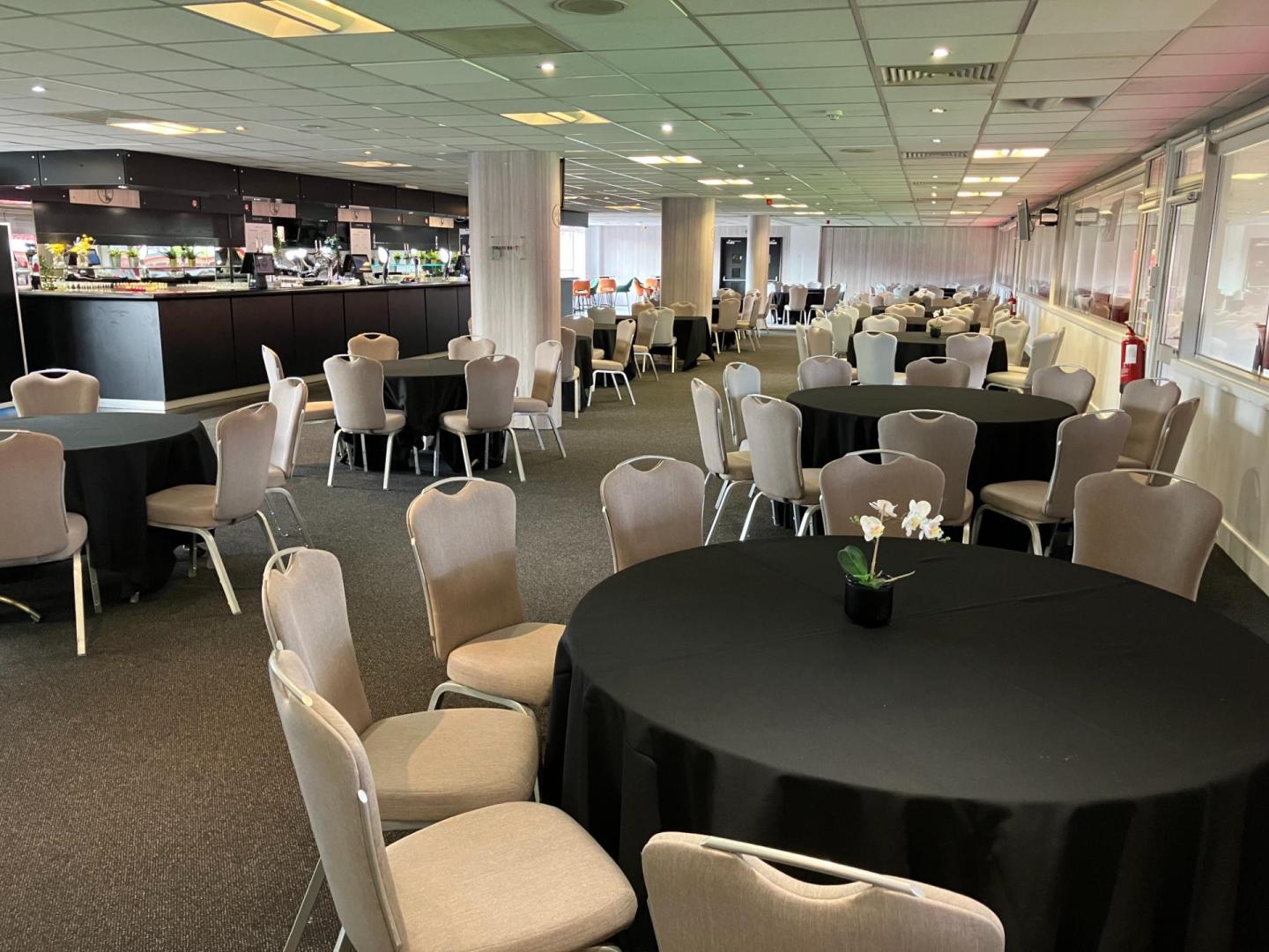 Club 1905 Lounge at Charlton Athletic, elegant event space with round tables for gatherings.