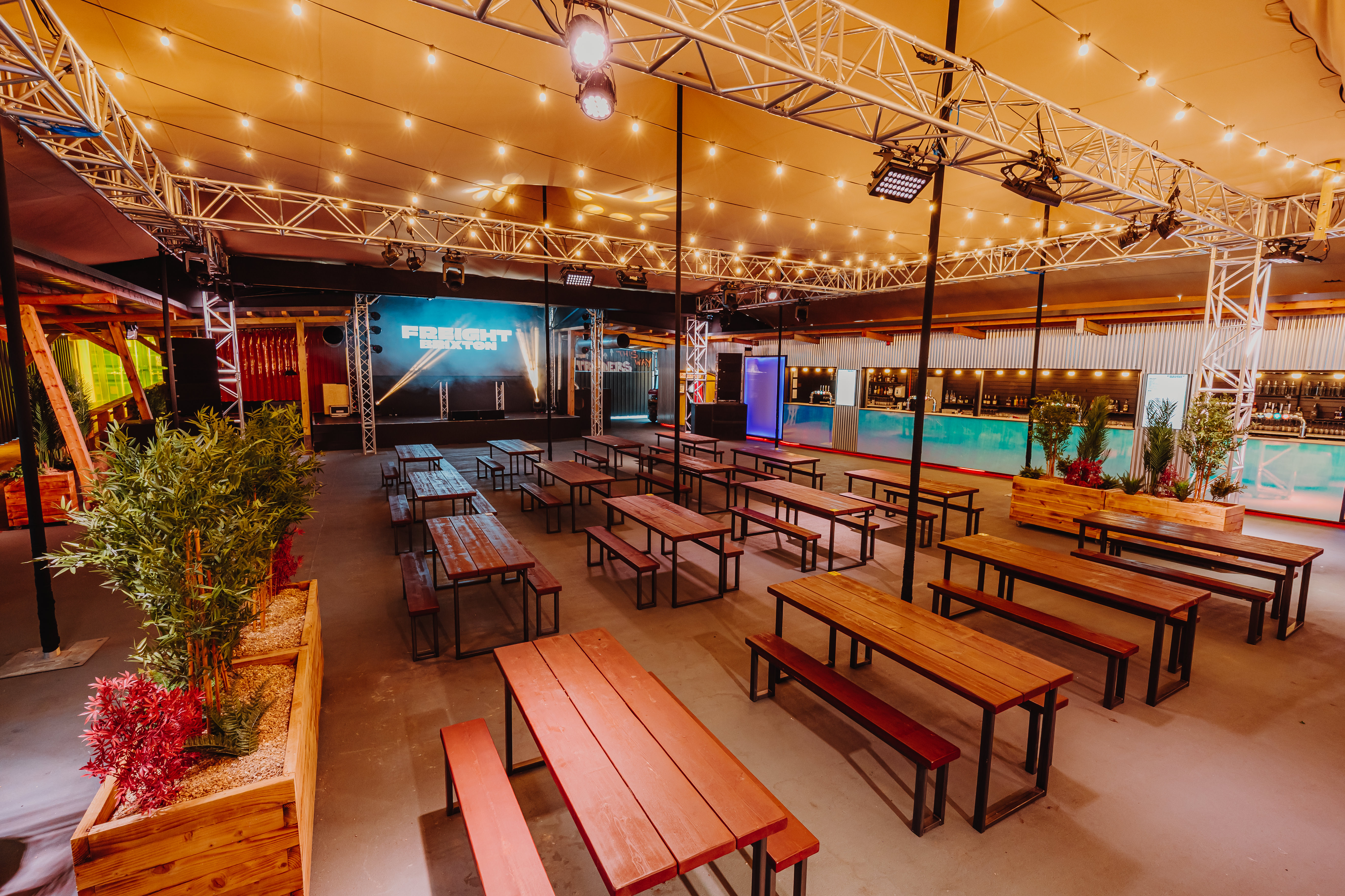 Industrial event space with bench seating for networking and social activations at Freight Brixton.