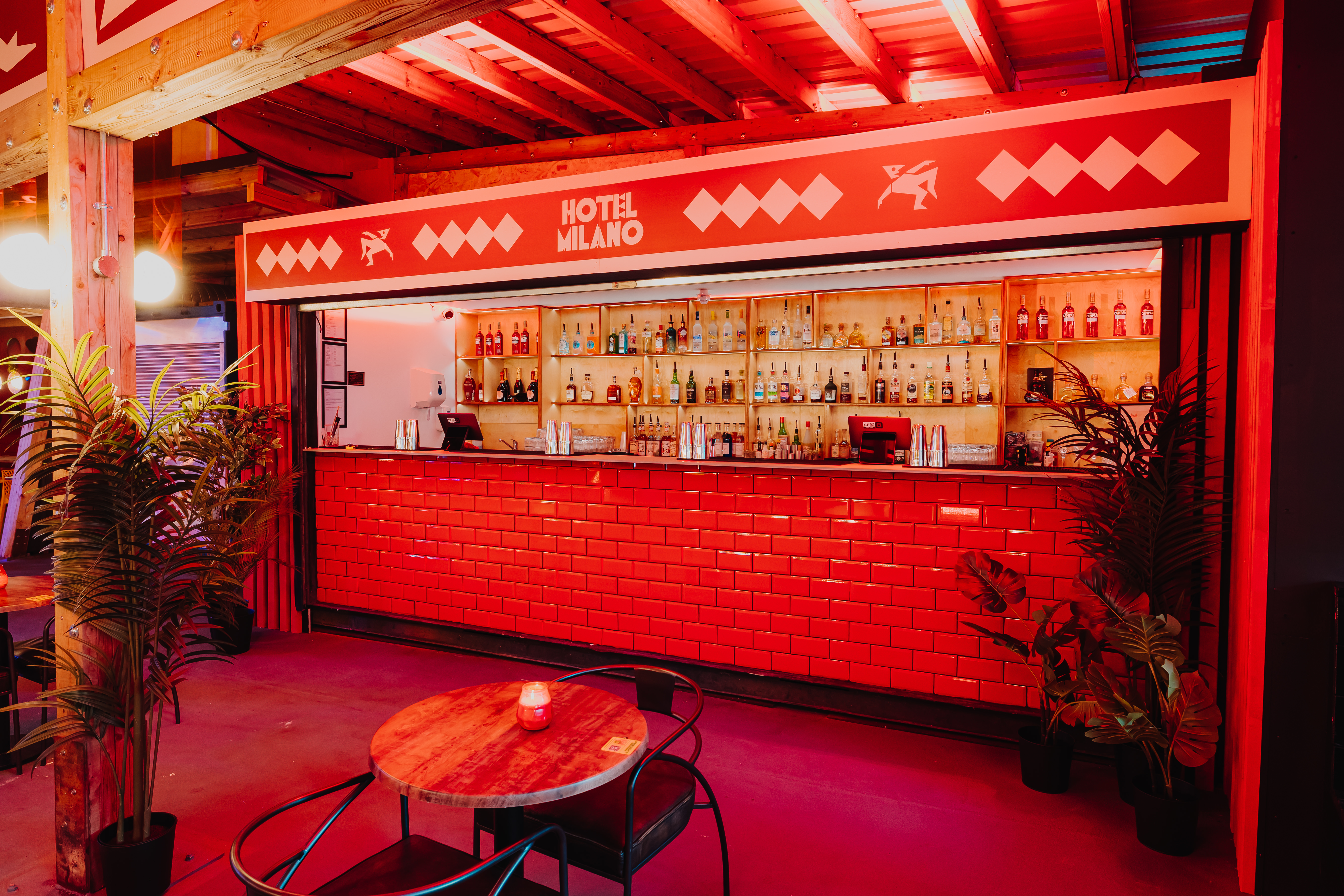 Red monochromatic pop-up bar at Hotel Milano Freight Brixton for networking and brand activations.