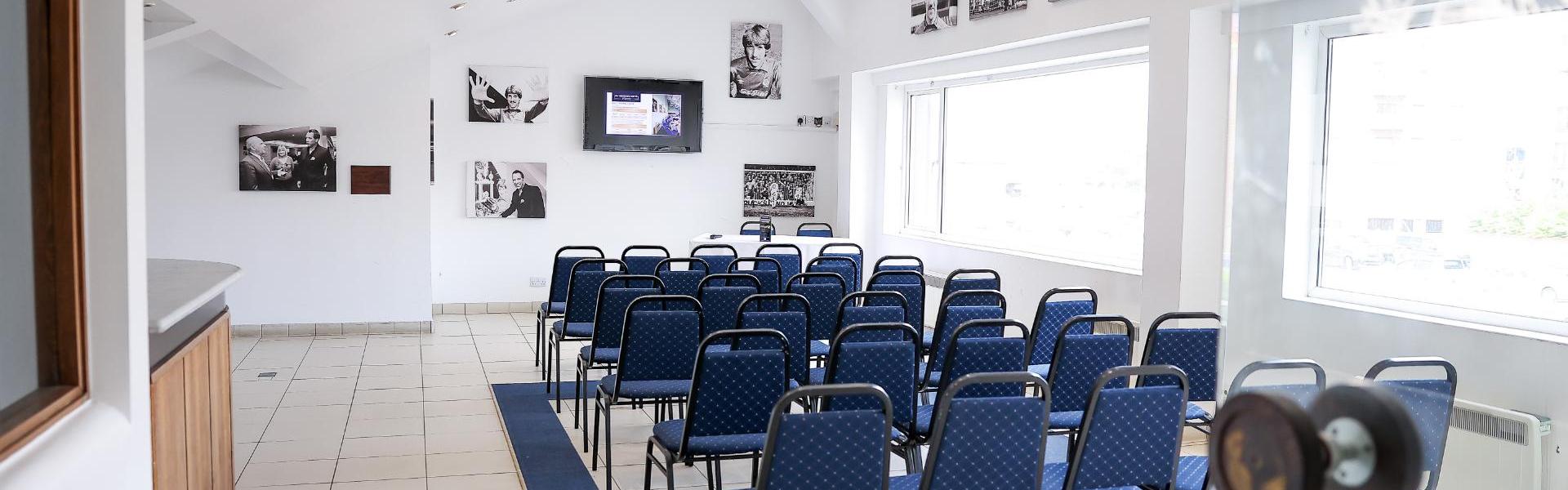 Executive Suite at Peterborough FC, bright meeting space with blue chairs for events.