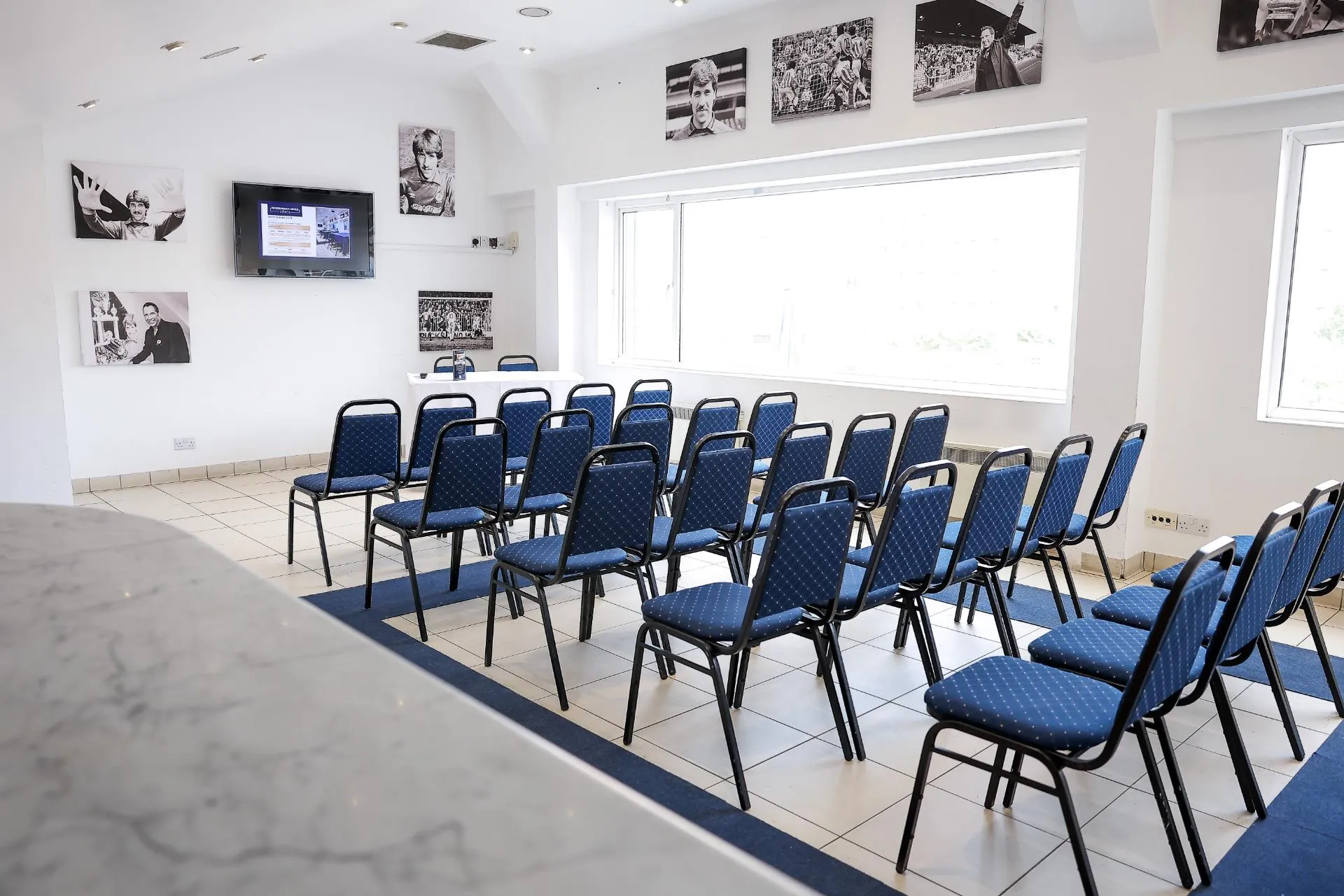 David Seaman Suite with blue chairs, ideal for corporate meetings and workshops.