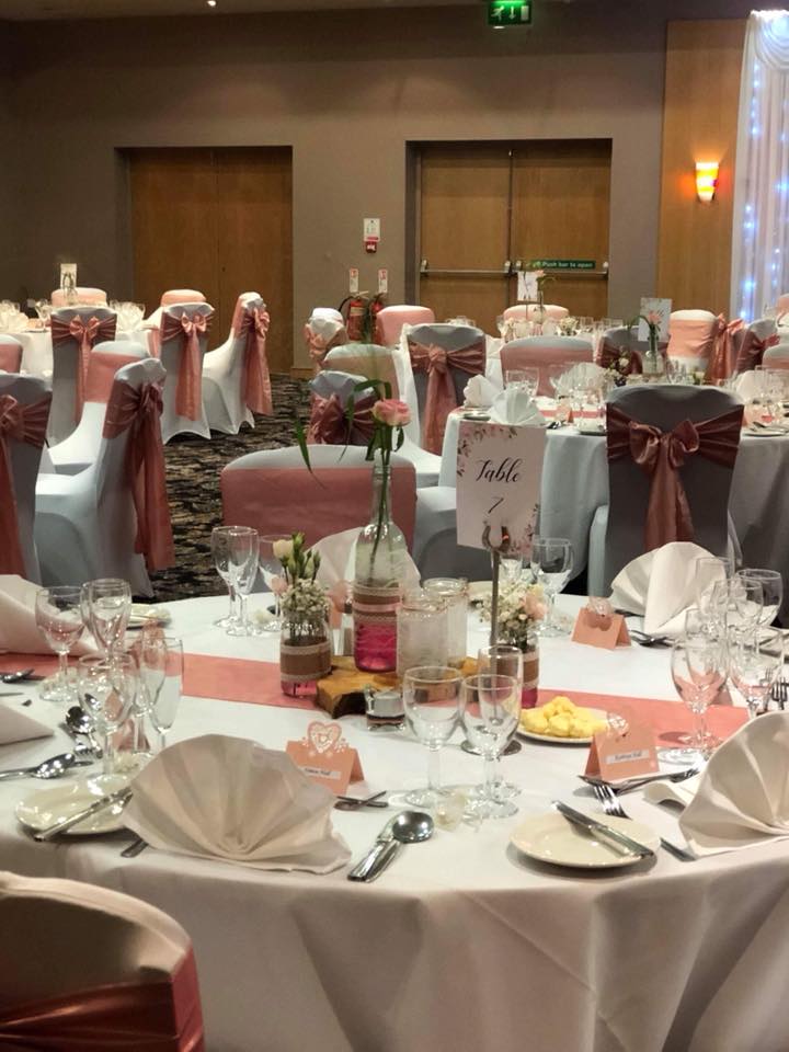 The Merlot Suite banquet room with elegant table settings for weddings or formal events.