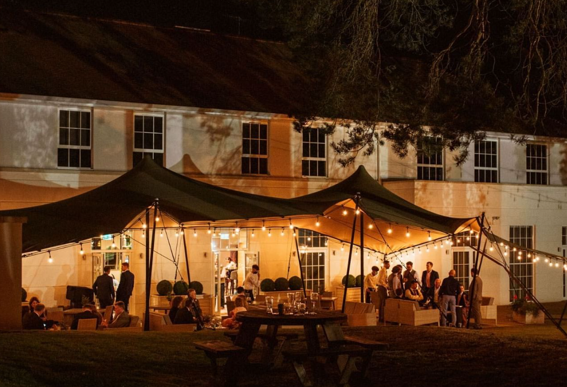 Illuminated outdoor event space at Gorse Hill Hotel, perfect for gatherings and networking.
