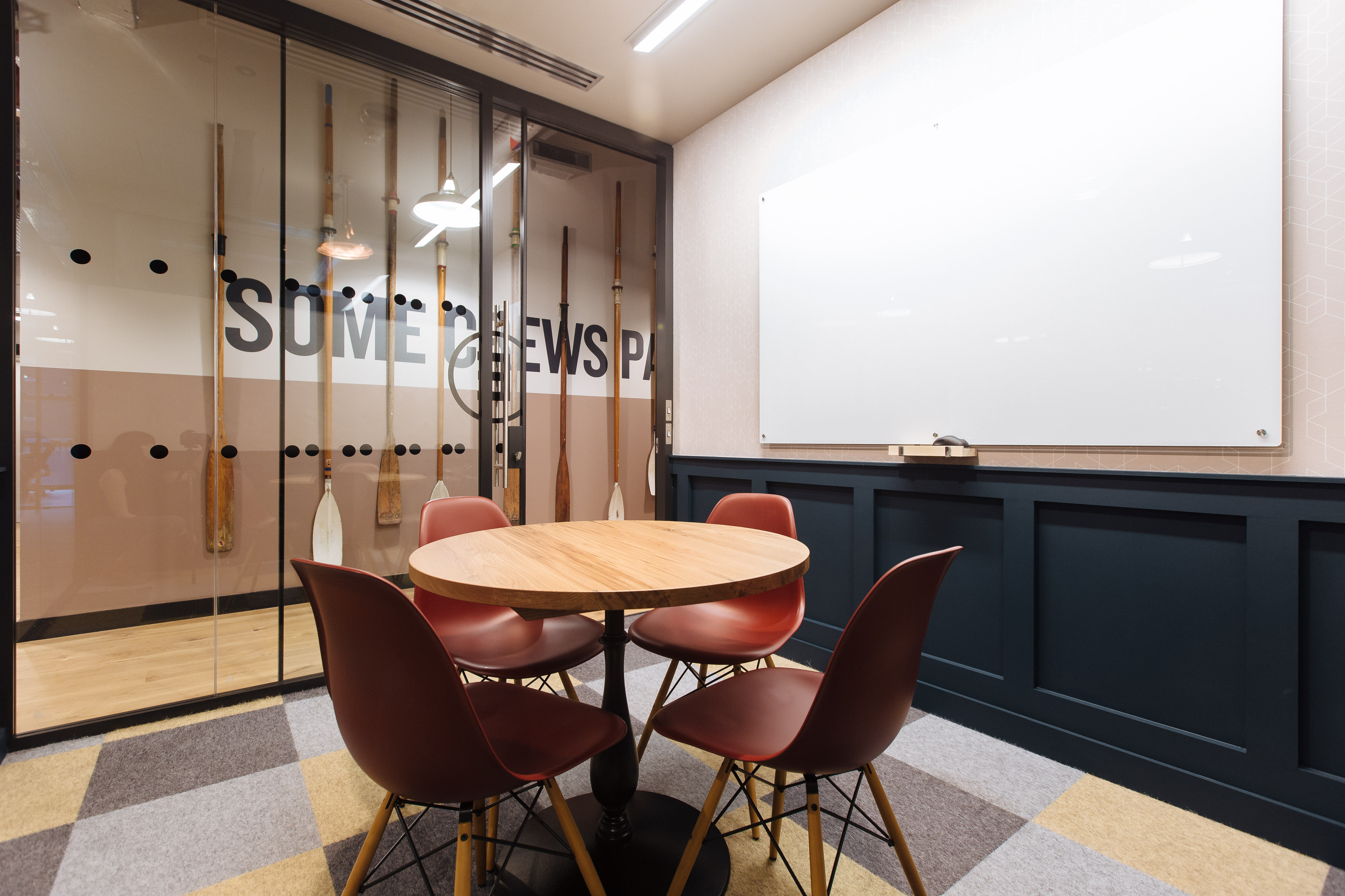 Modern meeting room at WeWork 145 City Road with round table, ideal for team collaboration.