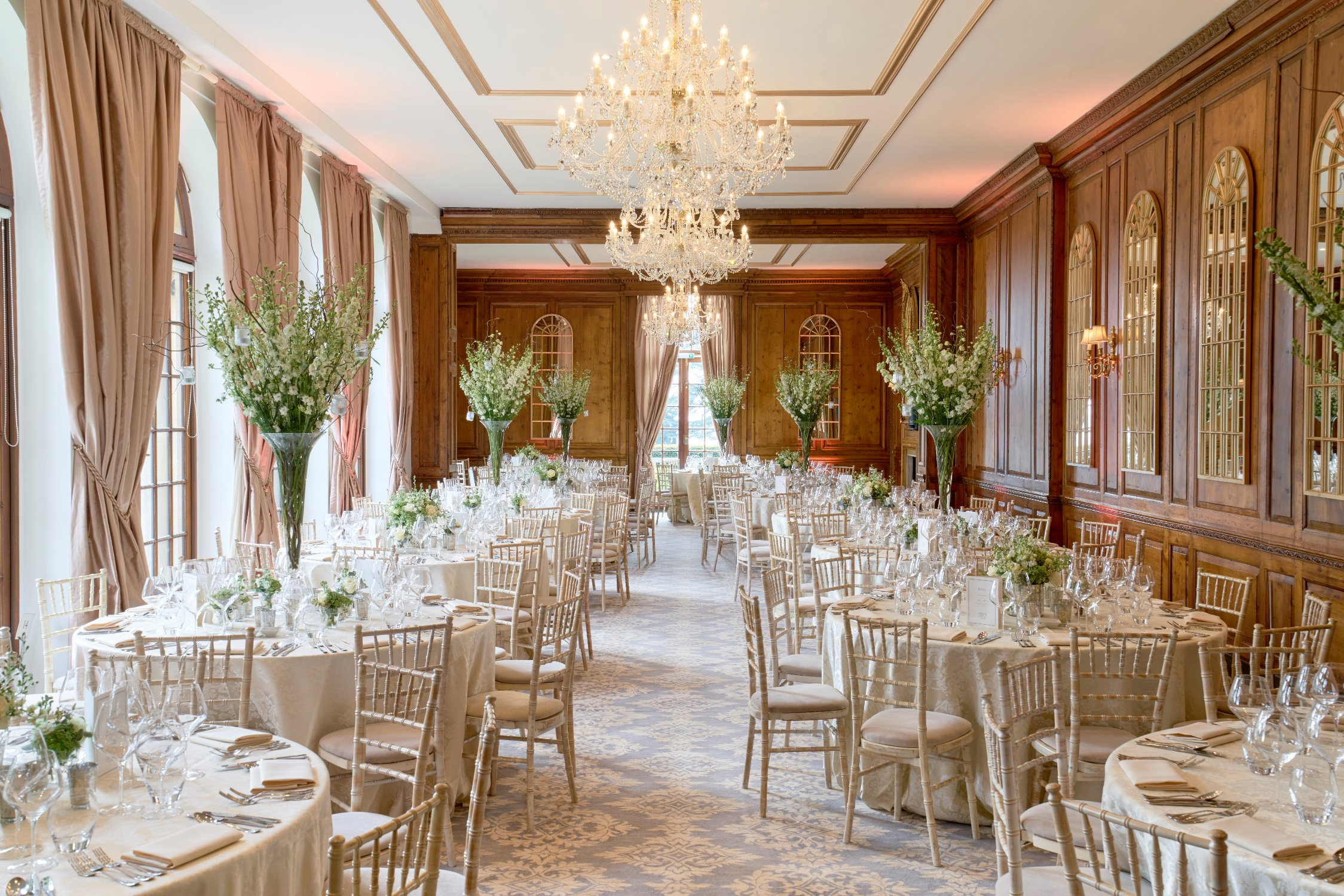 Elegant Hedsor House ballroom with banquet tables and floral centerpieces for luxury wedding gala.