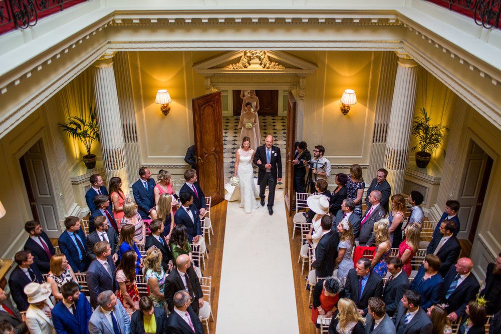 Hedsor House ballroom wedding ceremony with elegant columns and aisle runner for luxury events.