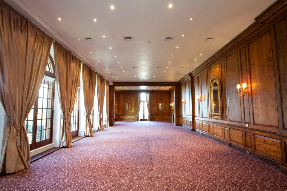 The Ballroom at Hedsor House with wood paneling, ideal for corporate dinners and elegant receptions.