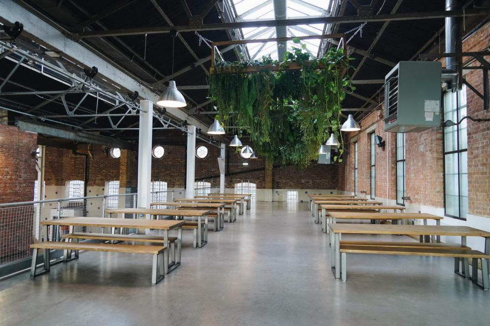 Industrial event space with rustic brick walls, ideal for workshops and receptions.