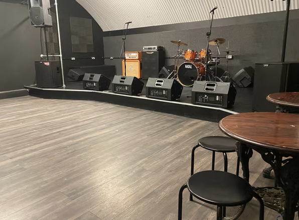 Live music performance stage with sound equipment in versatile event space.