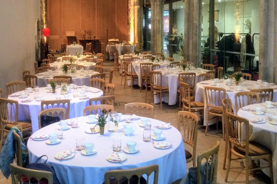 Elegant event space at St Ethelburga's Centre with round tables for banquets.