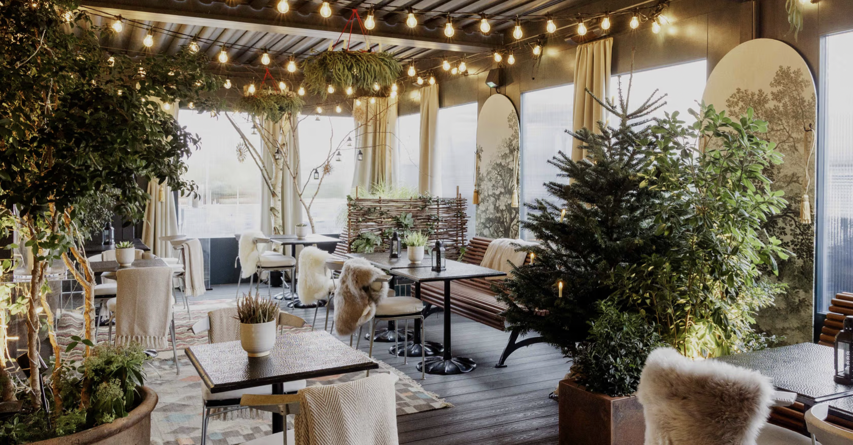 Elegant rooftop event space with greenery and lights, perfect for intimate gatherings.