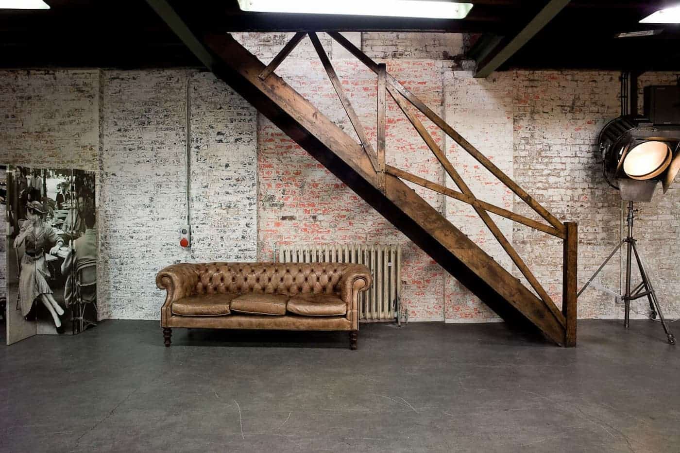 Warehouse & Chapel: stylish industrial event space with vintage leather sofa and exposed brick.