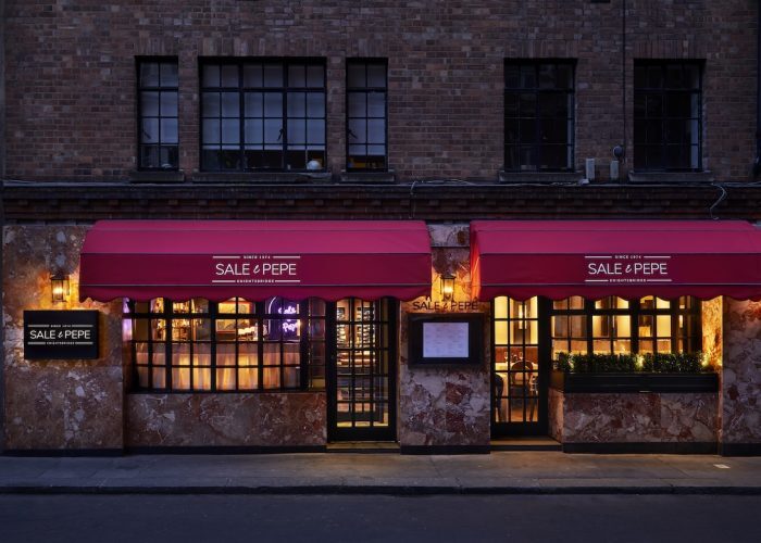 Private dining room at Sale e Pepe Knightsbridge with red awnings, ideal for intimate events.