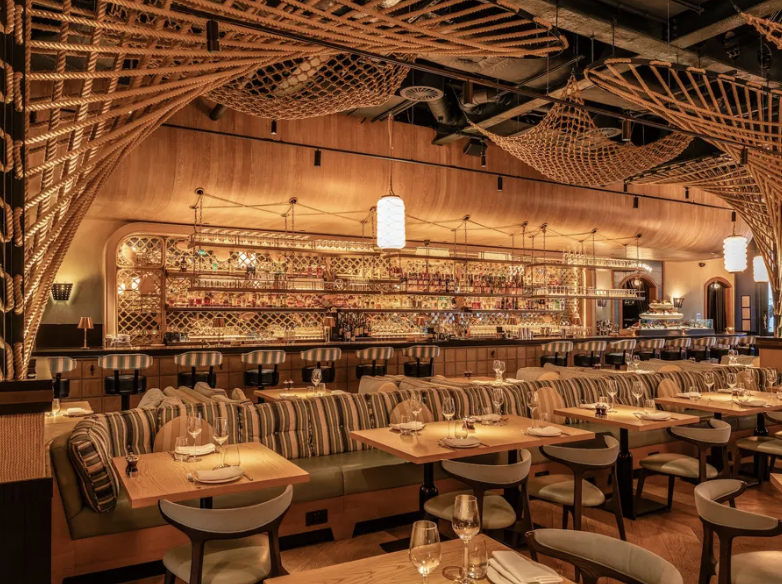 Amalfi Glass Dining Room with striped banquettes, perfect for intimate events and gatherings.