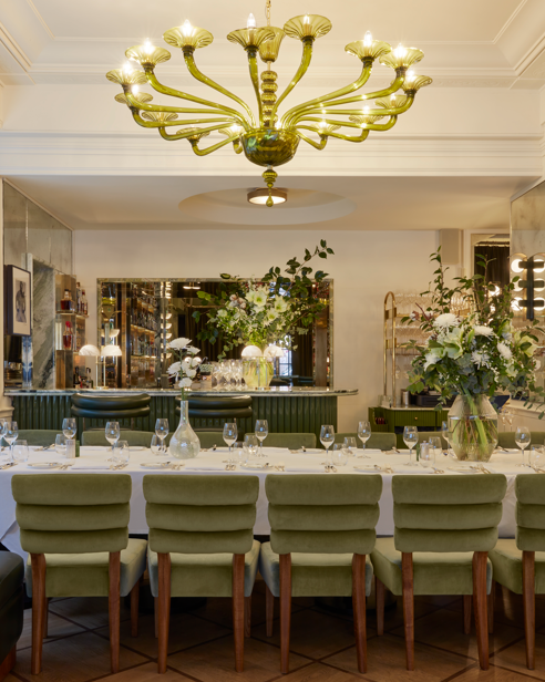 Mural Room at Langan's Brasserie, elegantly set for corporate events with lush greenery.