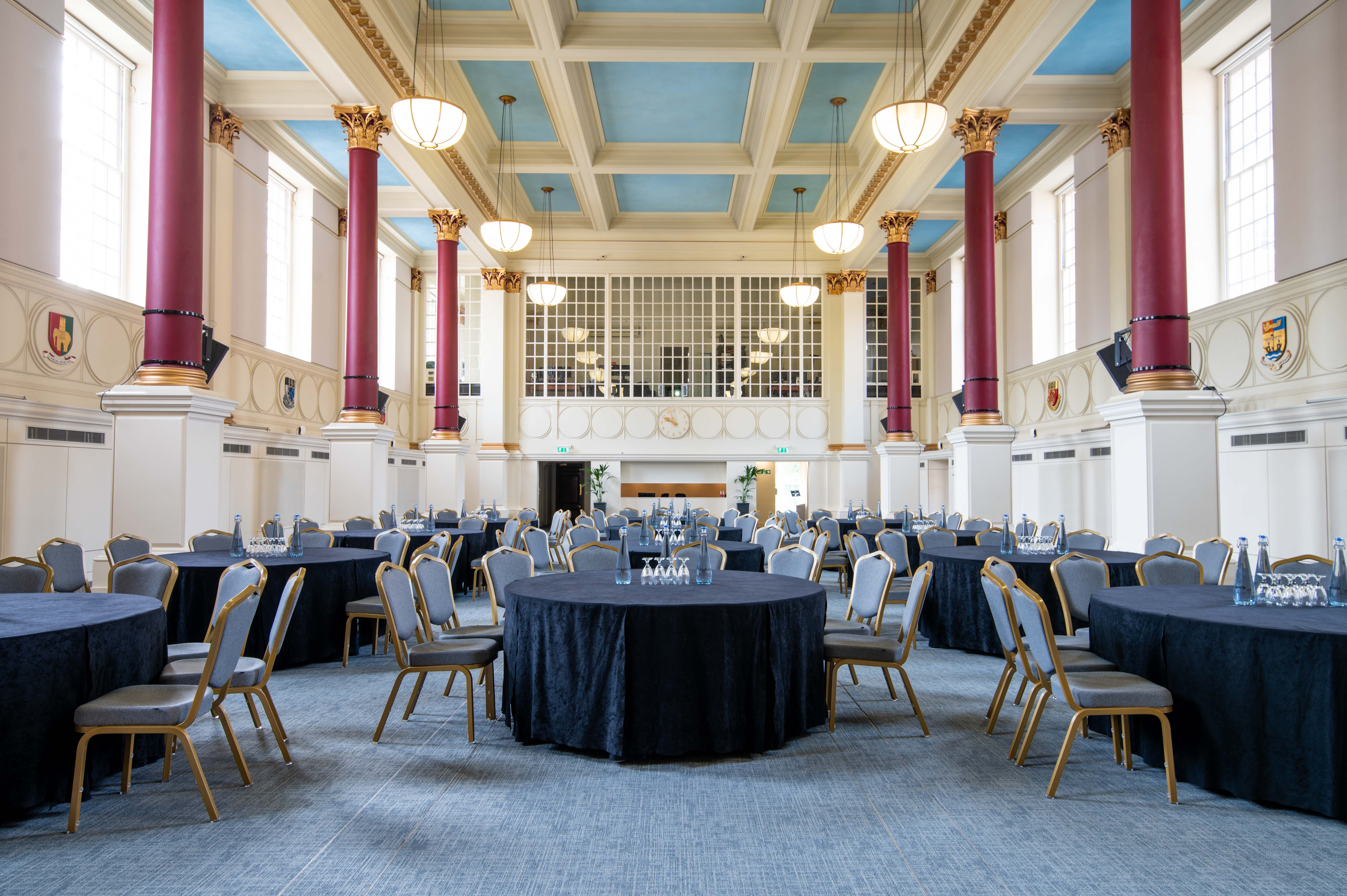 Low-Impact DDR event space with round tables and natural light, ideal for conferences and galas.