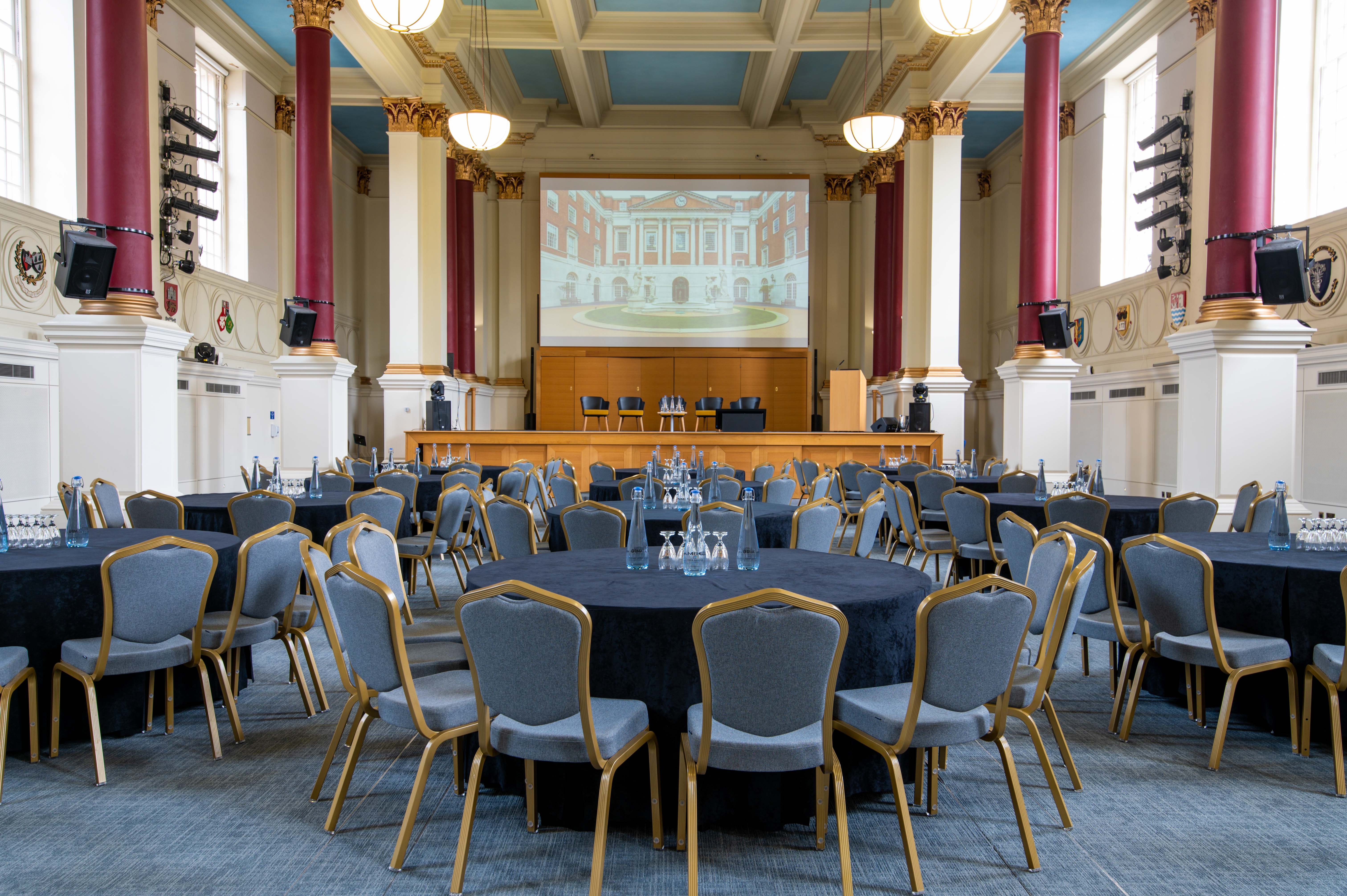 Low-Impact DDR event space in BMA House with elegant décor and tables for conferences.