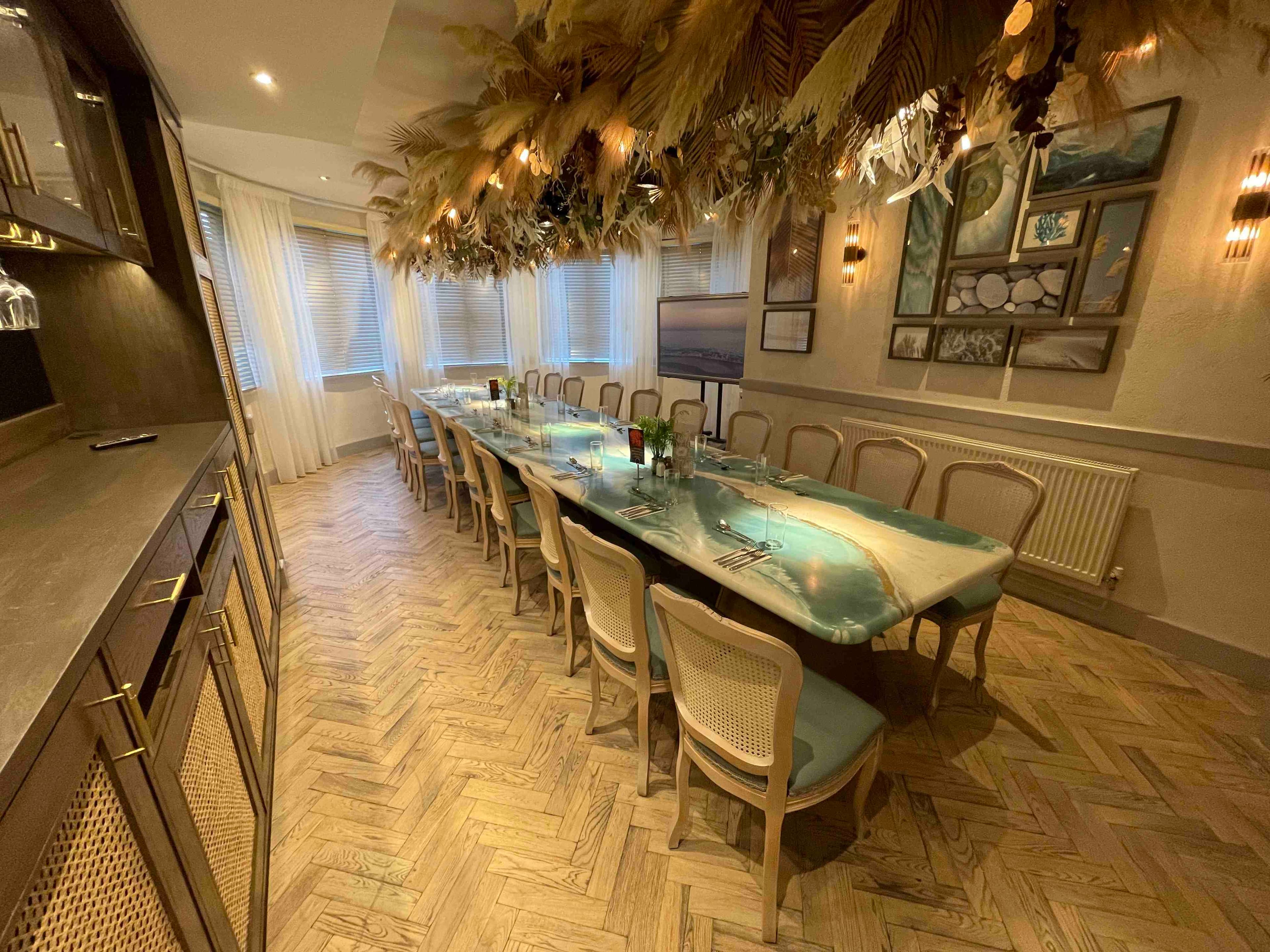 Elegant meeting room with long table, ideal for intimate gatherings and corporate events.