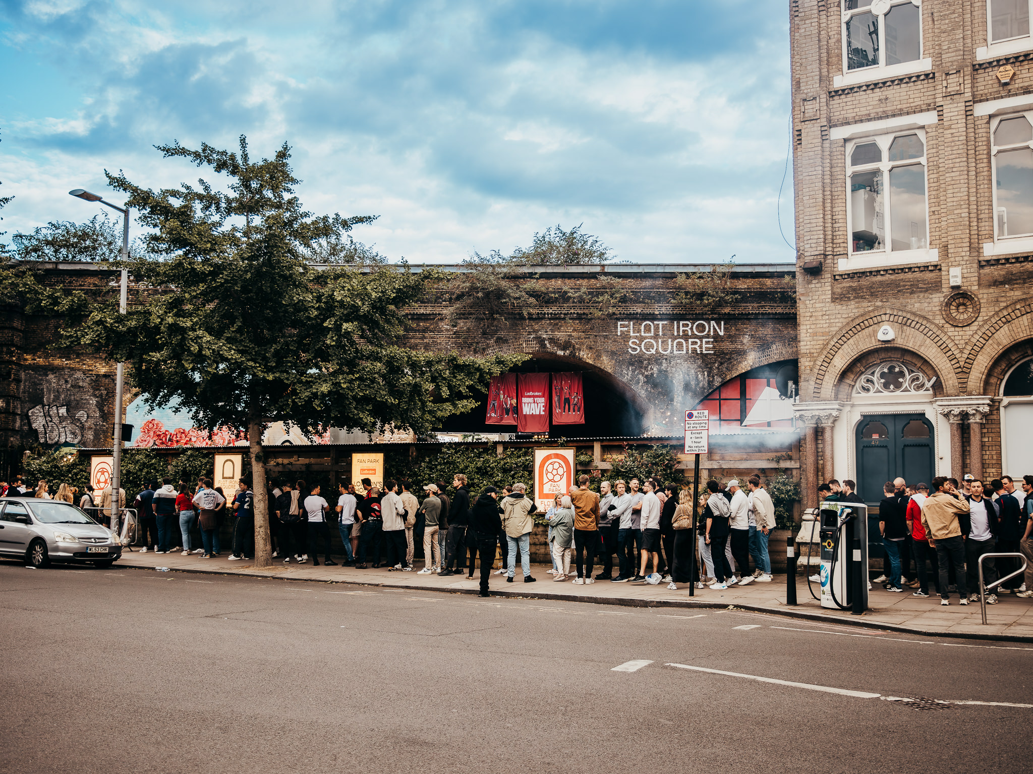 "Flat Iron Square venue with eager attendees, ideal for urban events and crowd management."