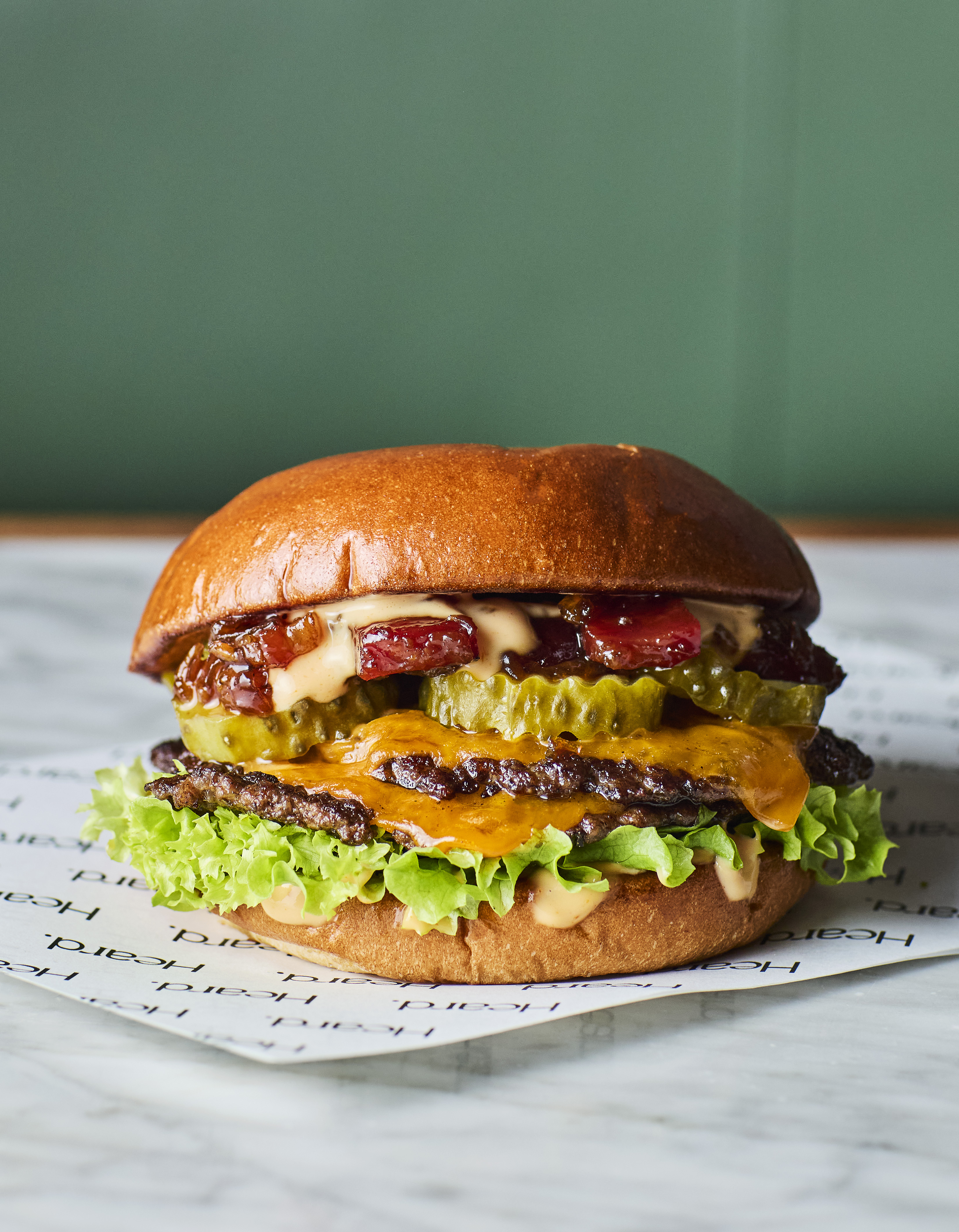 Gourmet burger with melted cheese and fresh lettuce, perfect for casual catering events.