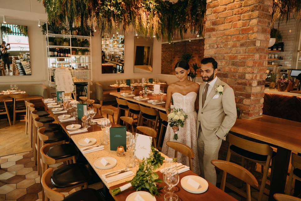 Intimate wedding reception at Basement Buyout with greenery and elegant decor.