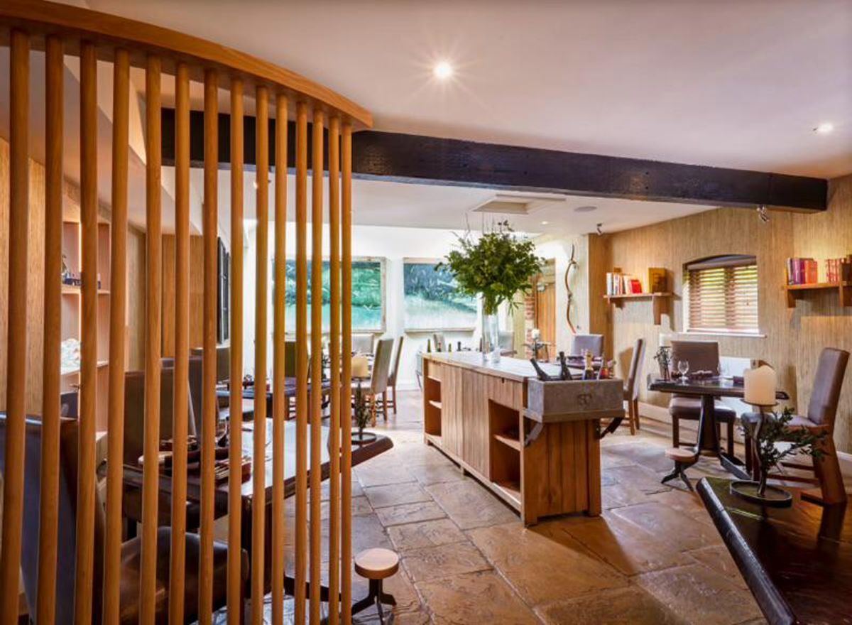 Stylish meeting space at Restaurant Sat Bains with warm wood accents, perfect for gatherings.