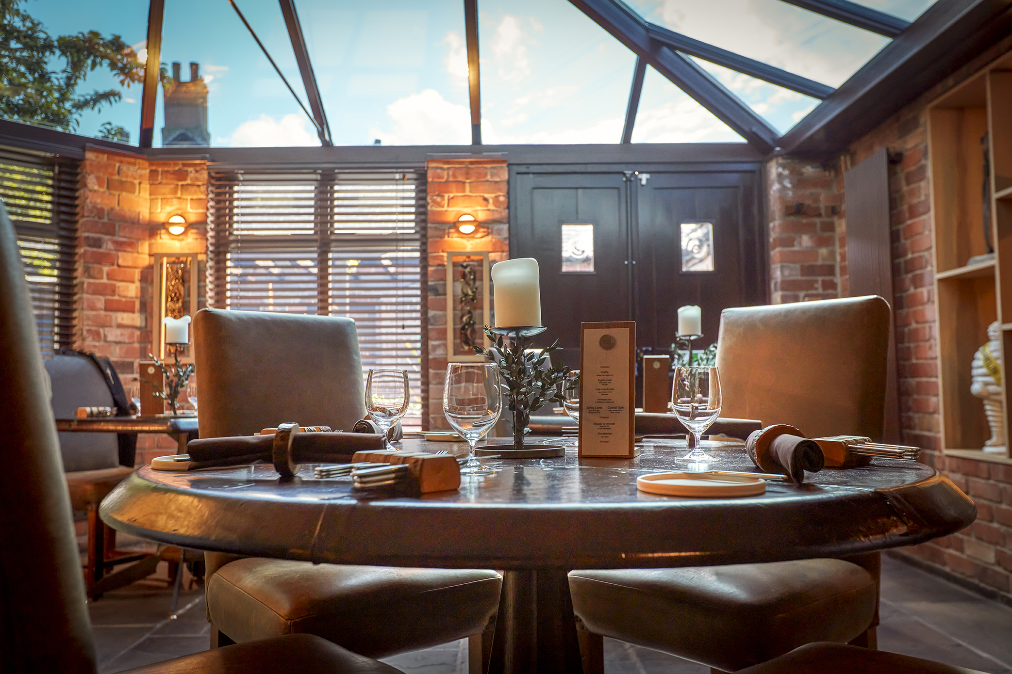 Elegant round table in upscale meeting space at Sat Bains Restaurant for corporate dinners.