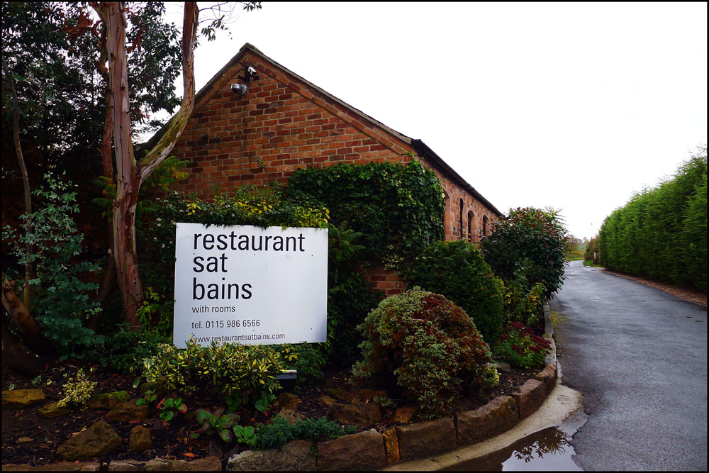 "Upscale Courtyard Garden entrance at Restaurant Sat Bains for elegant events and gatherings."