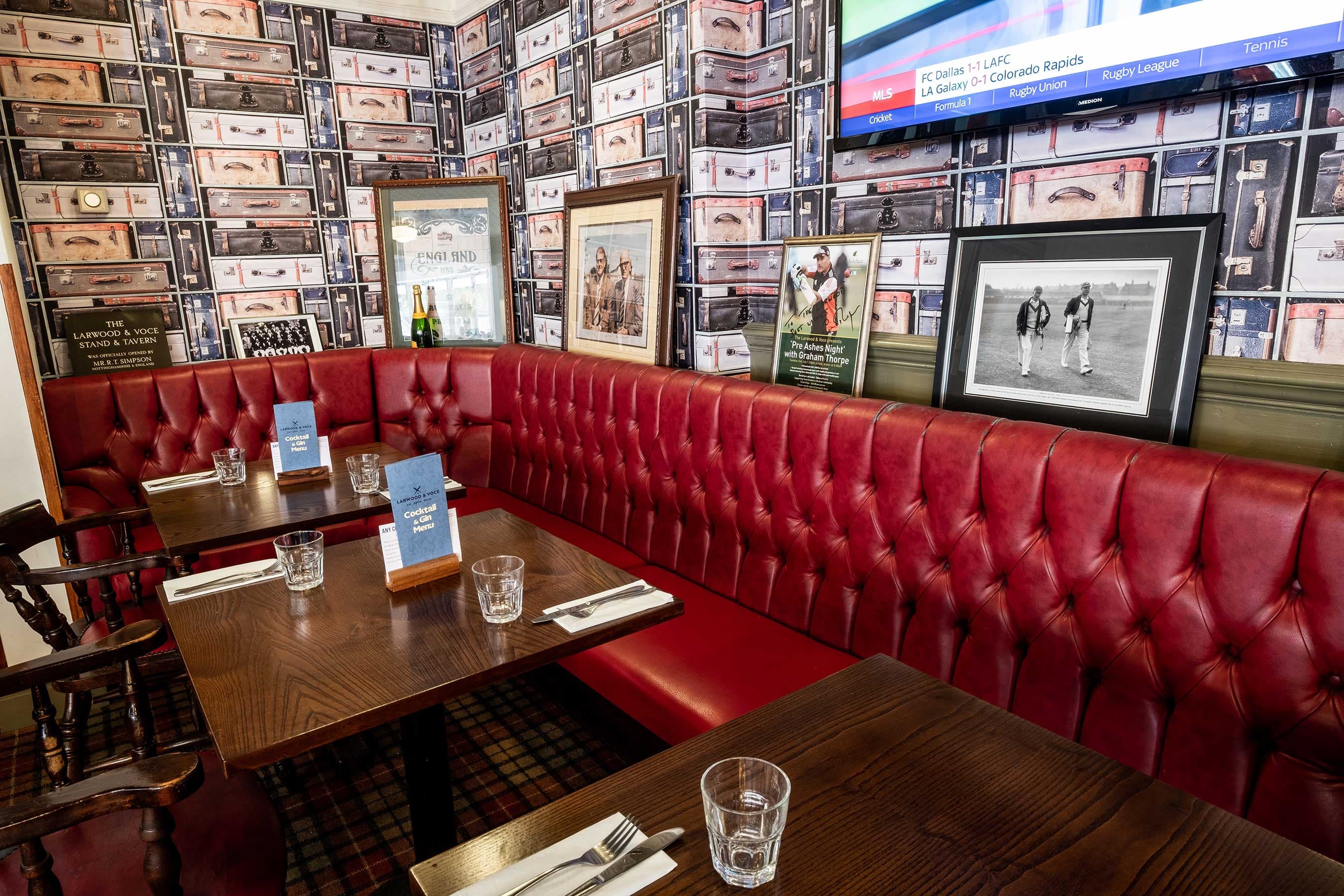 Cozy restaurant venue with red booths for intimate meetings and gatherings.