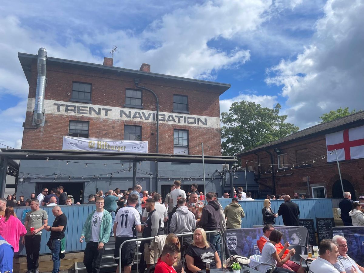 Outdoor gathering at The Big Shed, vibrant crowd perfect for social events.