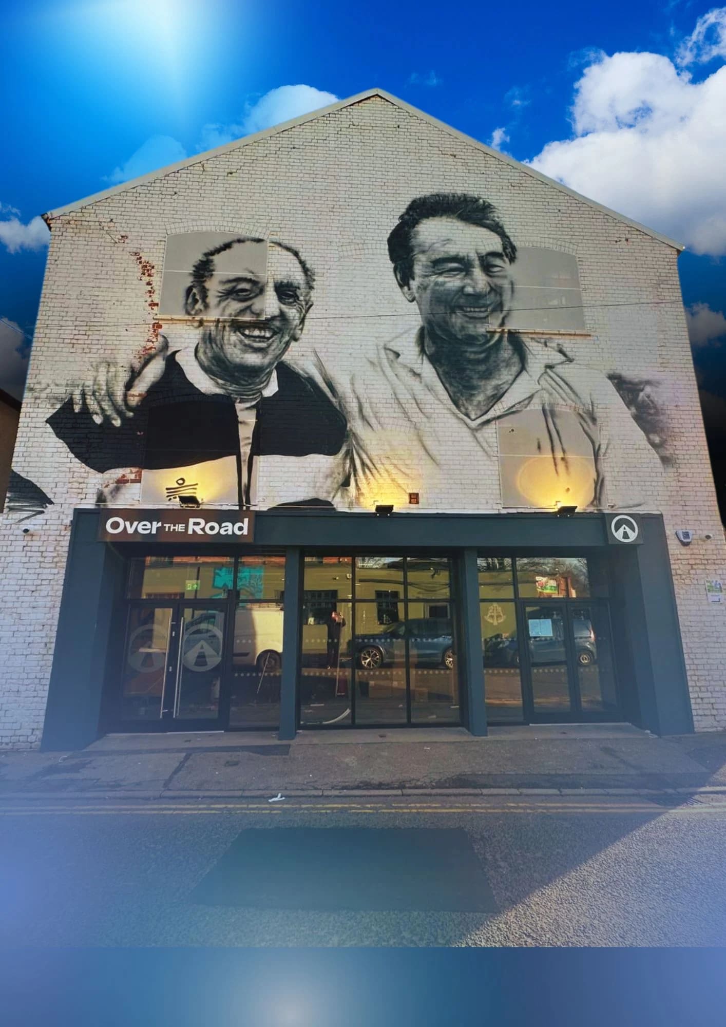 Mural of smiling figures at Ye Olde Trip to Jerusalem, perfect for events and gatherings.