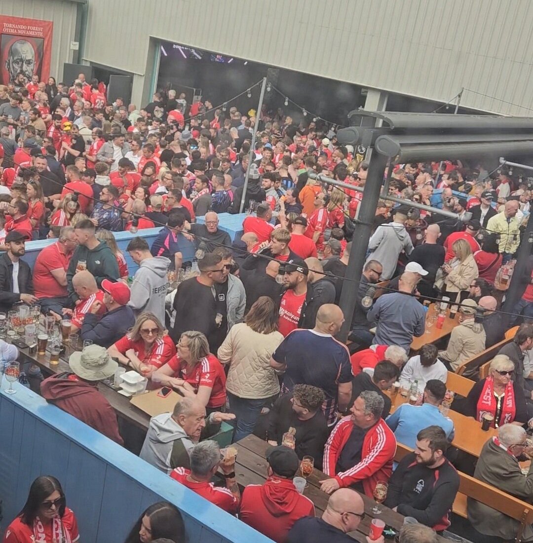 Lively outdoor pub scene with community vibe, ideal for sports watch parties and gatherings.