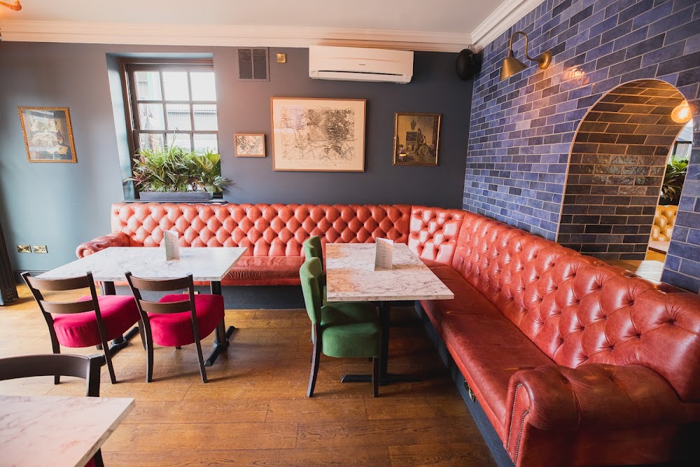 Cozy leather seating in The Pub, ideal for small events and networking.