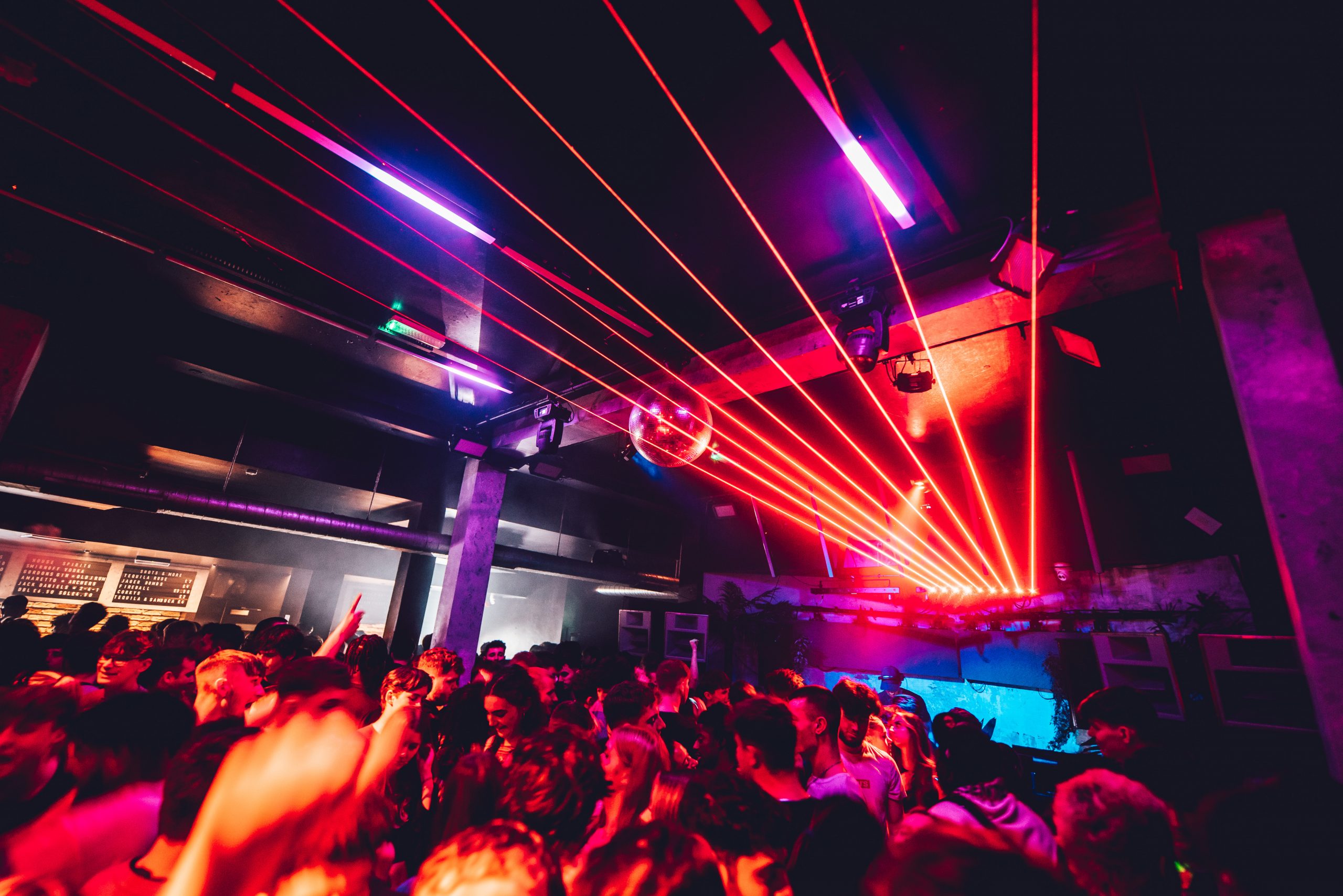 Vibrant nightlife event at Whole Venue in Stealth with dynamic lighting and packed crowd.