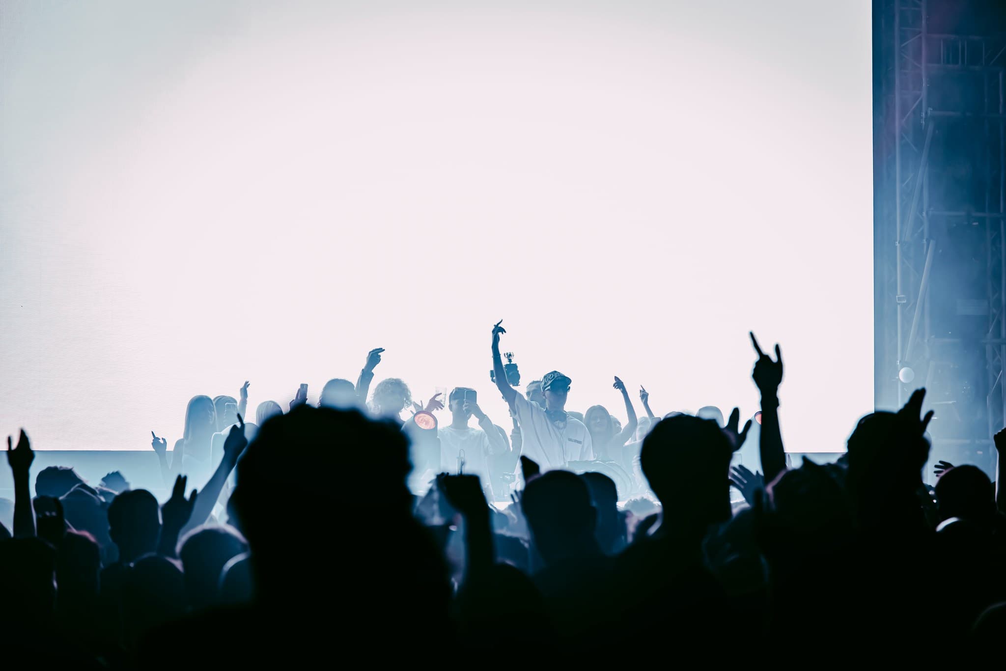 Lively crowd with raised hands at a vibrant concert event in Stealth room.